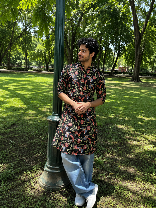 Man in a floral shirt standing in a park