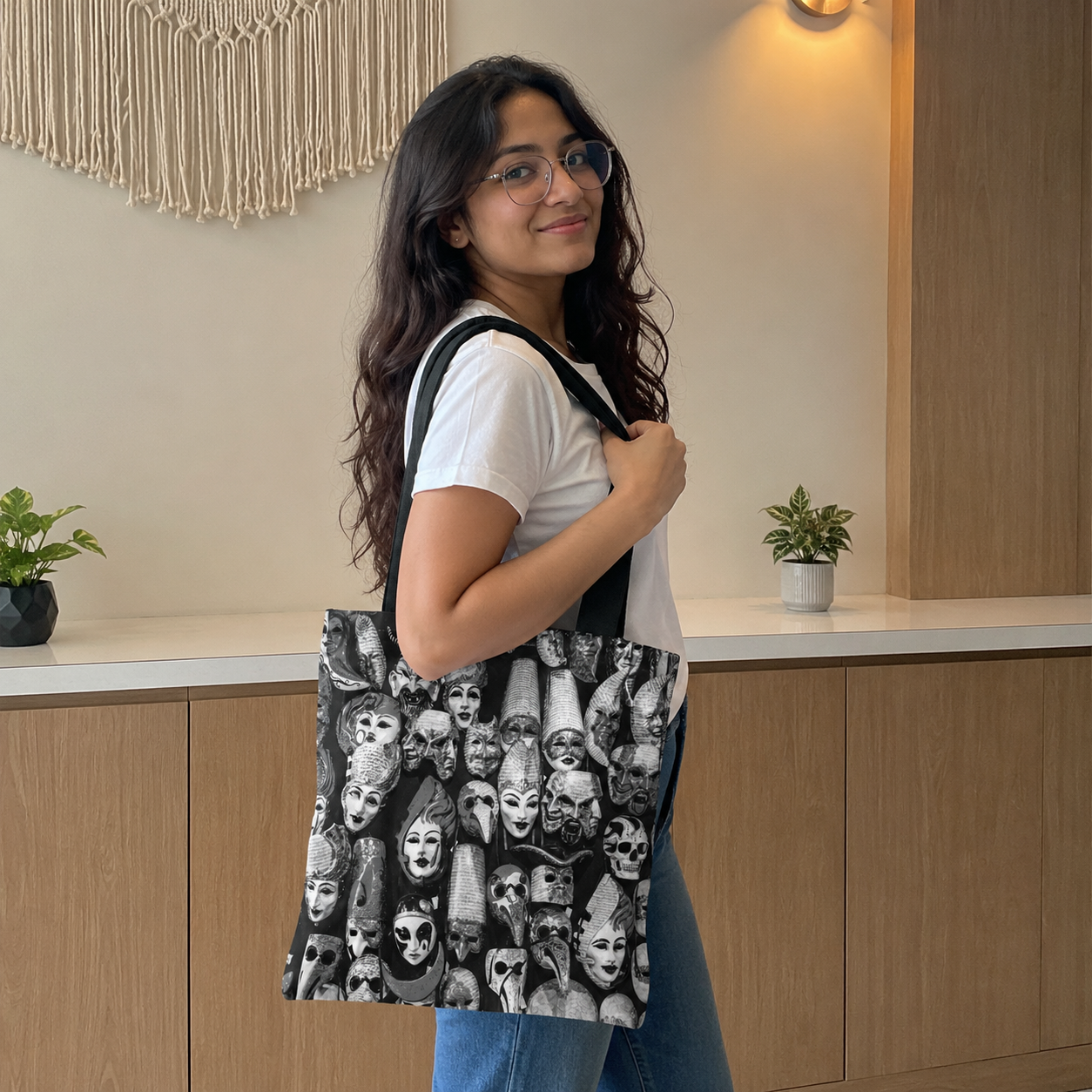 Woman holding a tote bag with a unique design in an indoor setting