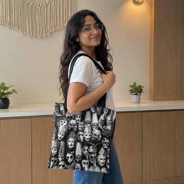 Woman holding a tote bag with a unique design in an indoor setting
