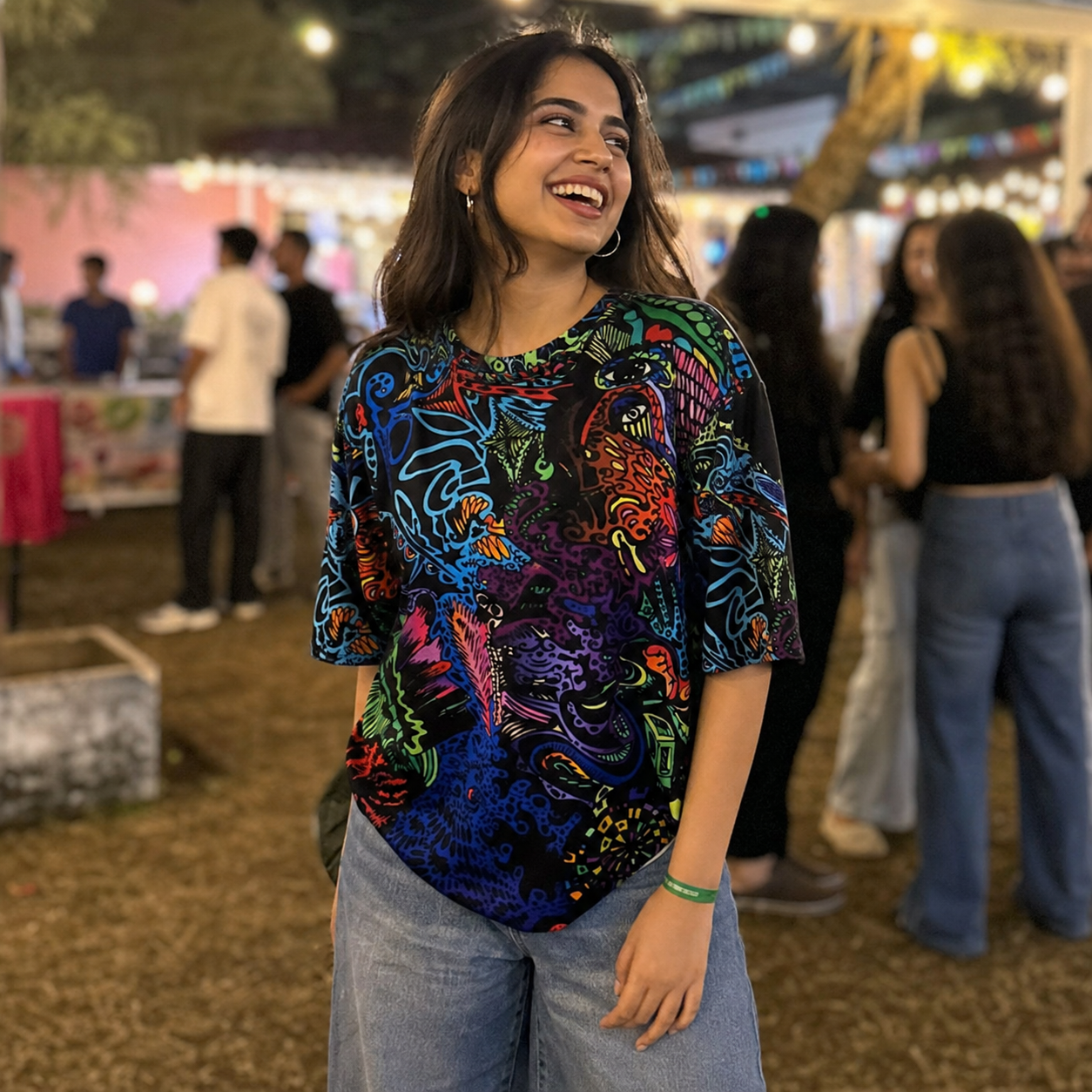 Woman wearing a colorful patterned shirt at an outdoor event