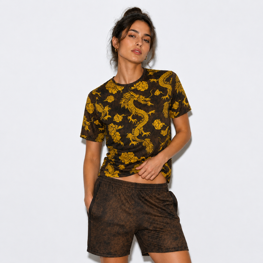Woman wearing a black t-shirt with yellow dragon patterns and matching shorts on a white background
