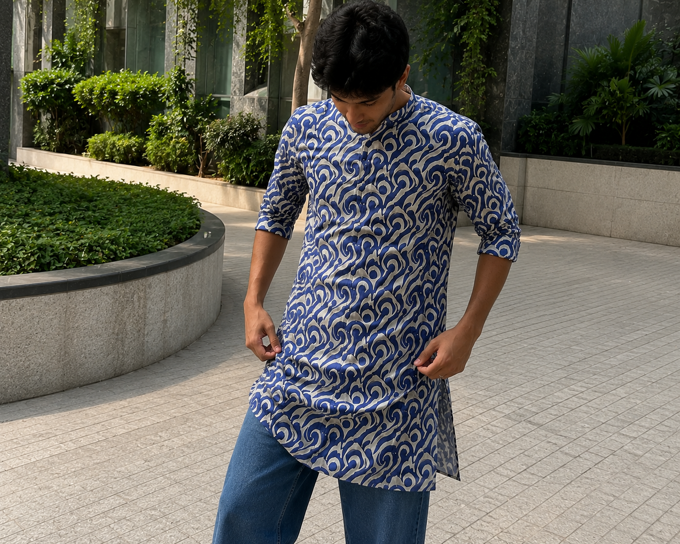 Person wearing a blue and white patterned kurta standing outdoors.