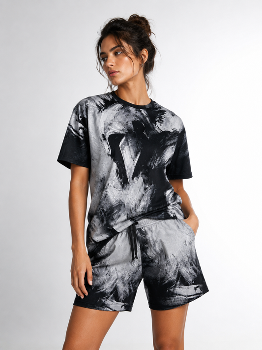 Woman wearing a black and gray abstract patterned outfit on a white background