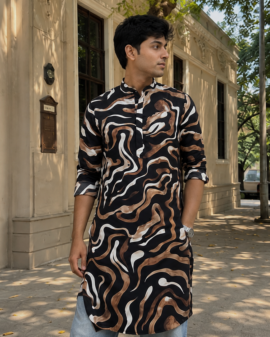 Man wearing a patterned shirt standing on a sidewalk with a building and trees in the background
