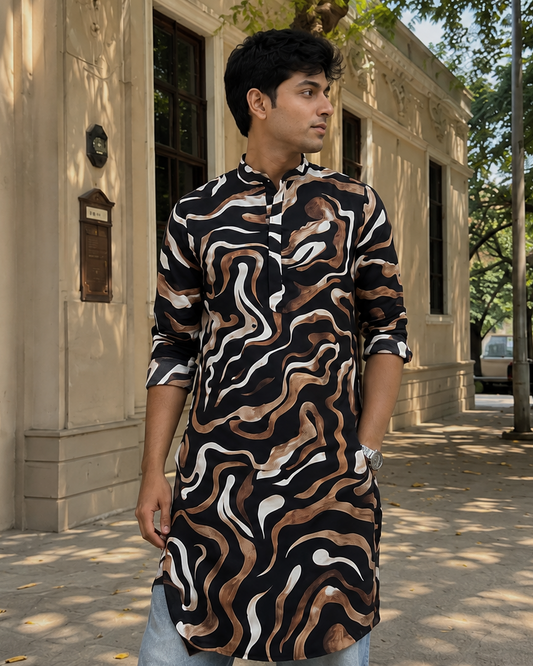 Man wearing a patterned shirt standing on a sidewalk with a building and trees in the background