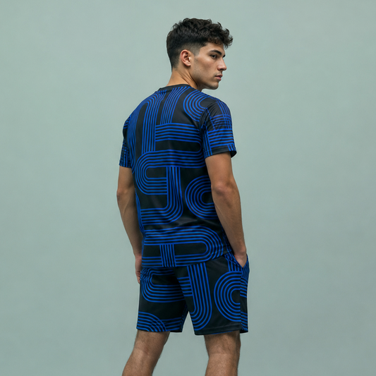 Person wearing a black and blue patterned outfit on a gray background