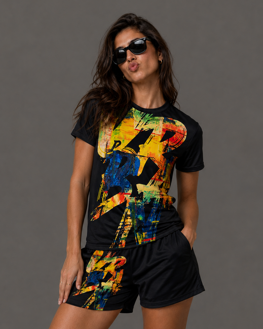 Woman wearing a black t-shirt and shorts with colorful abstract designs against a gray background