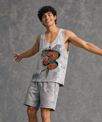Person wearing a tank top with a graphic design on a gray background